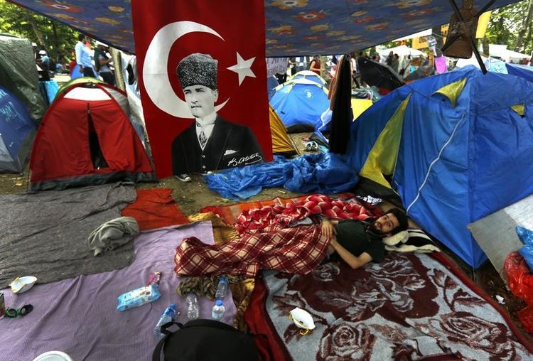 672338-an-anti-government-protester-rests-next-to-tents-in-gezi-park-in-istanbul-s-taksim-square